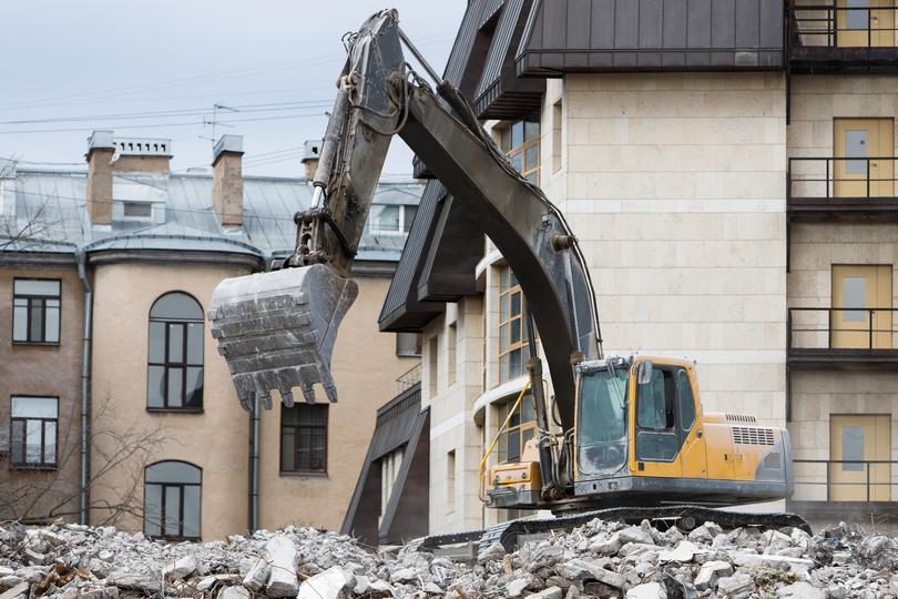 Demolition contractor demolishing a building