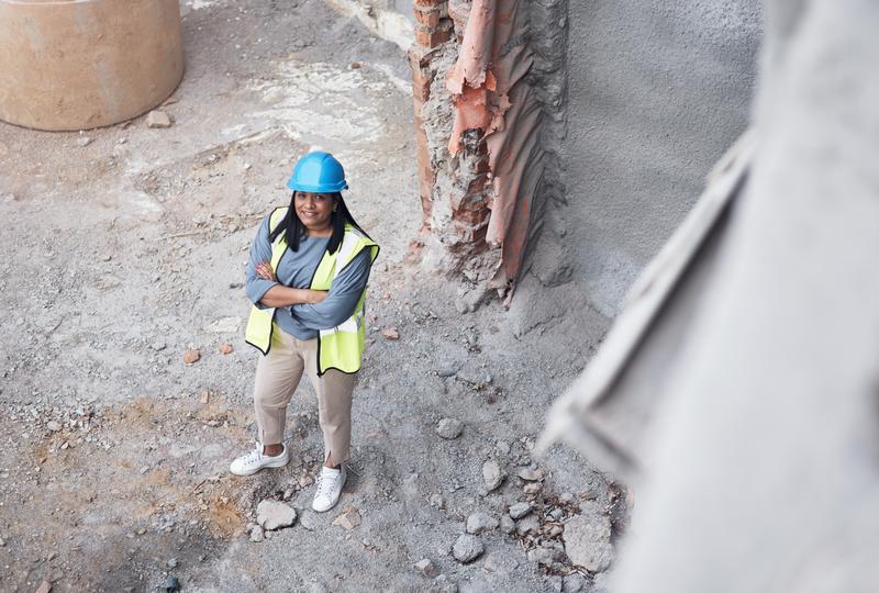 Worker operating a jackhammer for concrete demolition