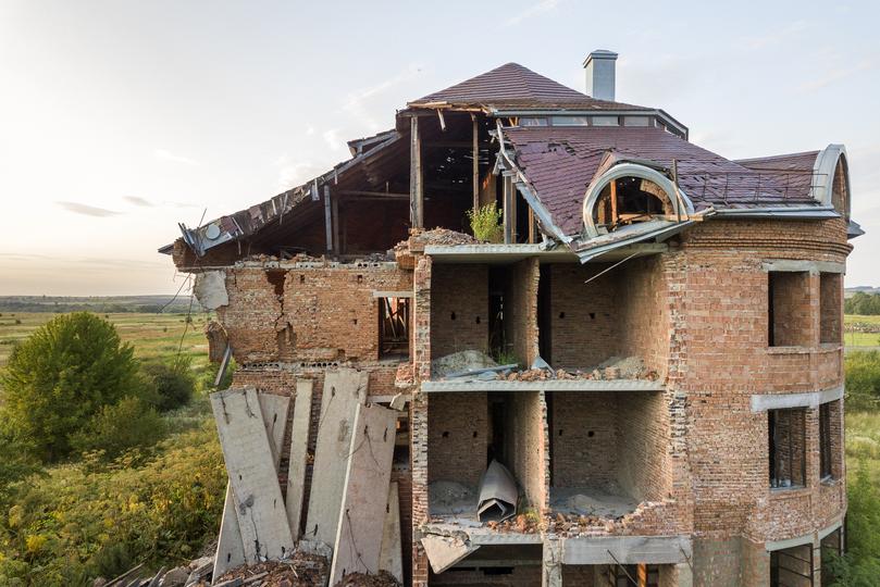 Demolition contractor demolishing a building