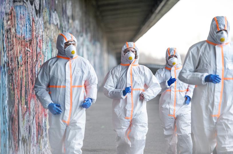 Asbestos removal specialists in protective gear safely removing asbestos-containing materials