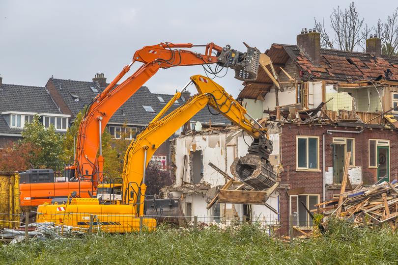 Demolition contractor demolishing a building