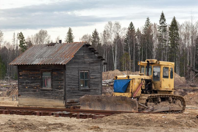 House being demolished by an excavator